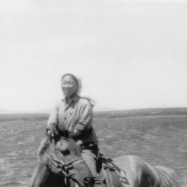 Black and white photo of a young lady on horseback
